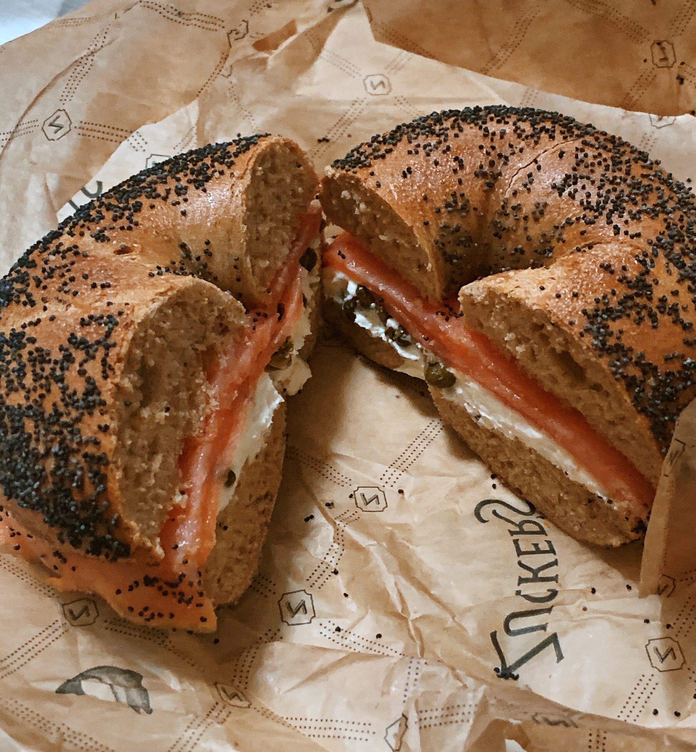 Poppy seed bagel with cream cheese salmon and capers