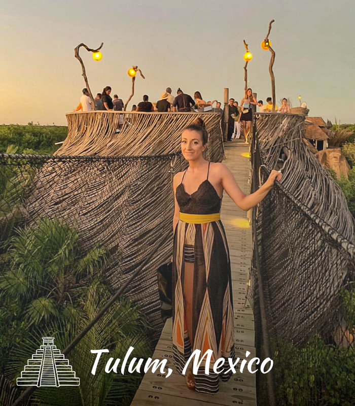 Girl on a suspension bridge iabove the jungle in Tulum Mexico