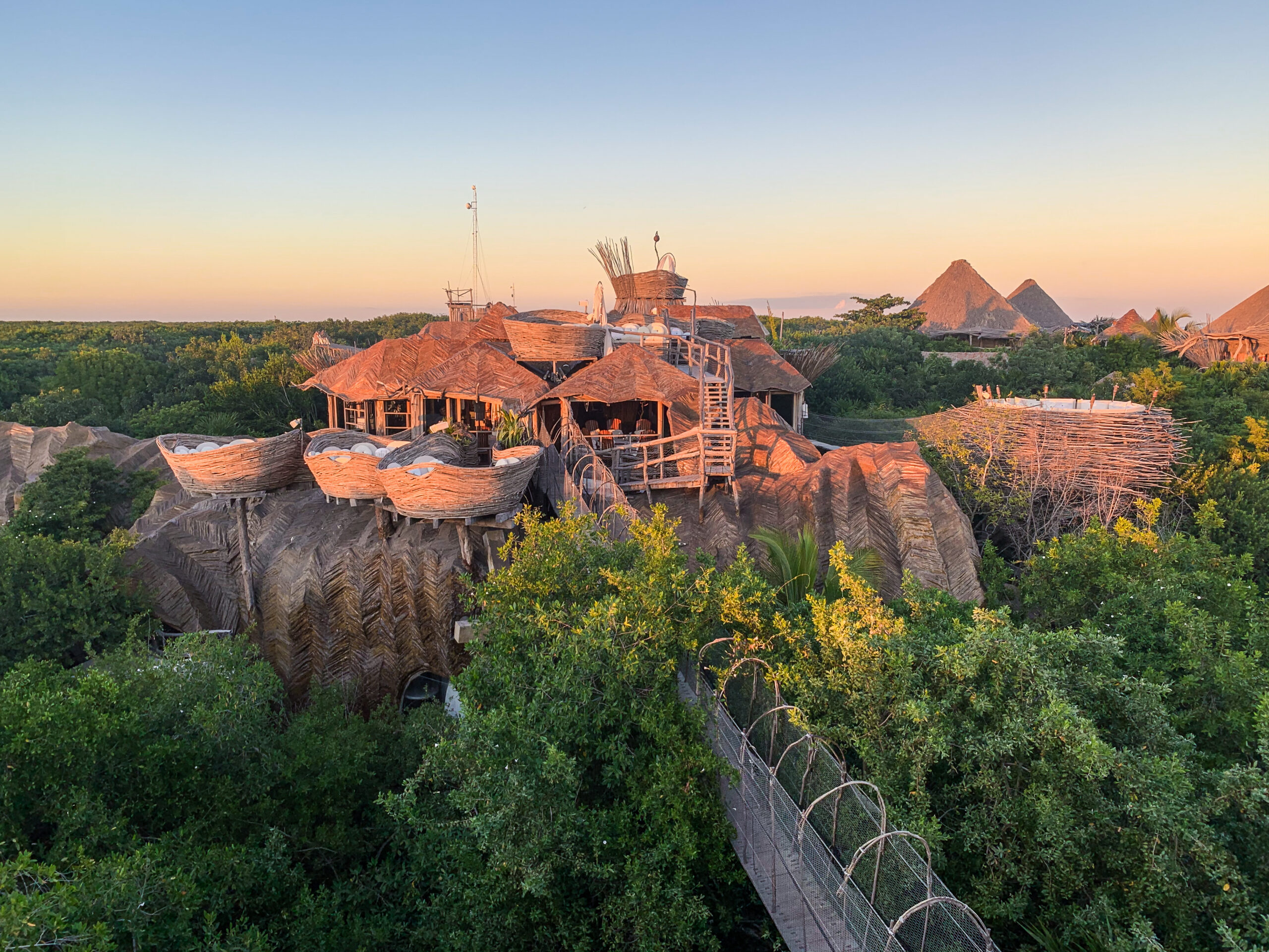 Sunset over an eco hotel in the jungle Azulik Tulum